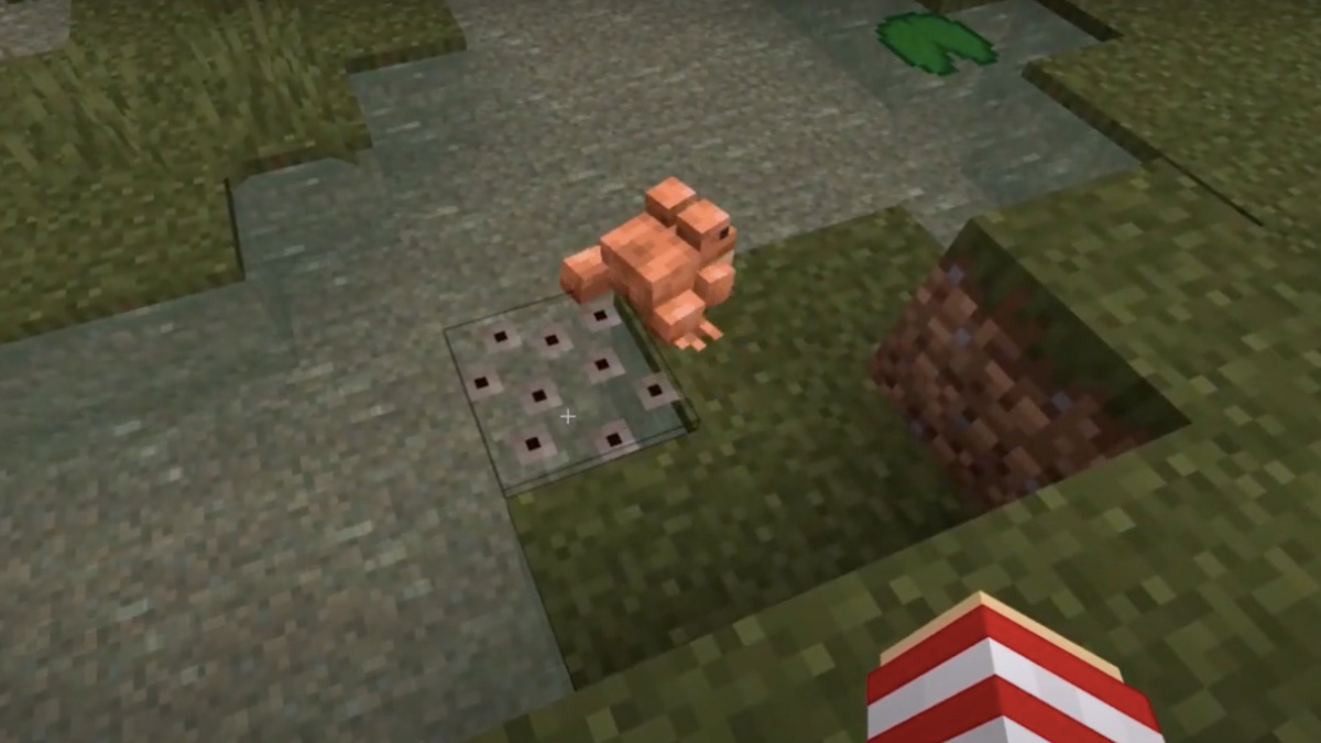 an orange frog laying eggs in minecraft