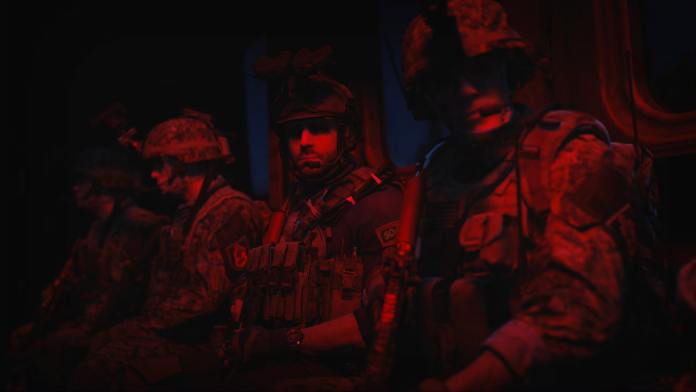 Three soldiers sitting side by side with red lighting in Modern Warfare 2